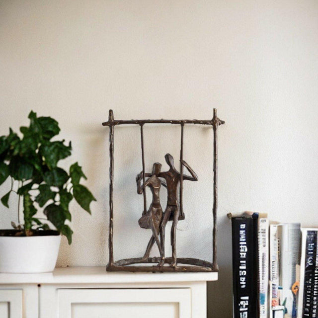 Couple on a Swing Cast Bronze Sculpture.